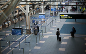 Travelers mill about at Vancouver International Airport in Richmond, British Columbia, Canada. The airport is worried about planes colliding with birds feeding on the multitude of ants.